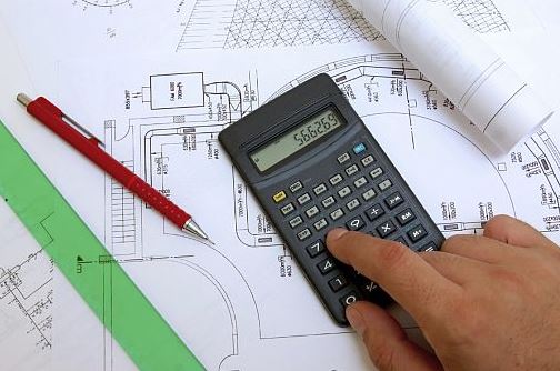 a calculator and blueprints