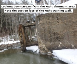 Looking downstream from the right abutment area. Note the section loss of the right training wall. 
