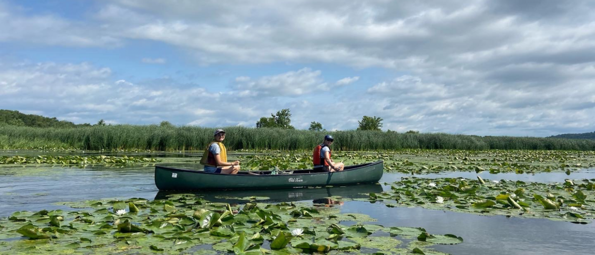 Two ECO members canoeing in a wetland area