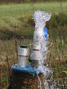 water gushing from well head