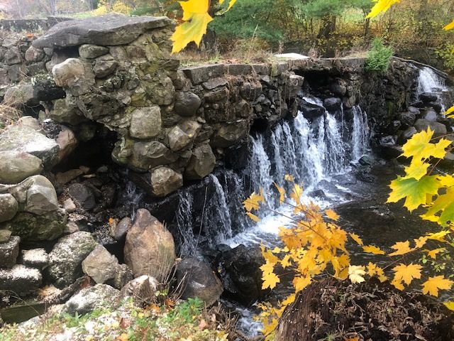 A stone dam is seen in the autumn