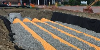 Yellow corrugated pipes and gravel for a stormwater treatment system