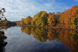 A screen snip of the image on the cover of the Basin 3 Tactical Basin Plan.  It shows a calm river with autumn foliage lining the shore.