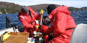 DEC staff collecting spring phosphorus samples from boat