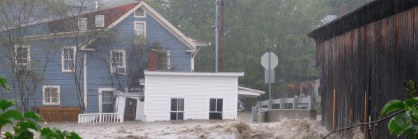 Flooded buildings next to covered bridge