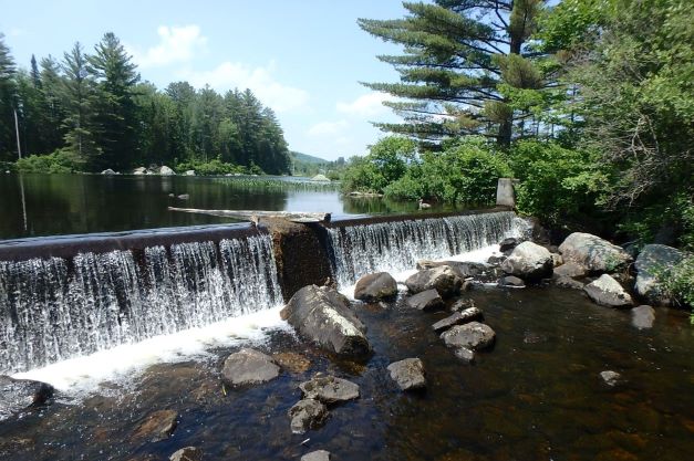 water flowing over dam into river