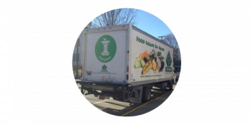 A box truck with the food scrap symbol on it--a white apple core within a green circle