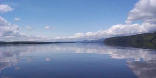 long view of Lake Champlain with blue sky and white clouds