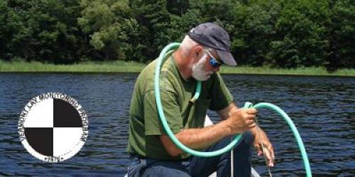 Man on boat with monitoring equipment. Image of Secchi disk in lower right corner