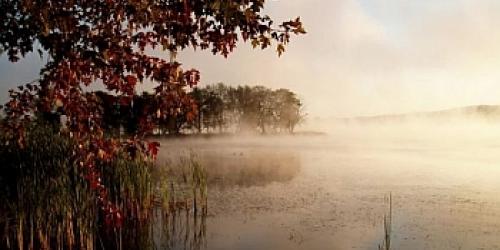 Lake Memphremagog with an island and mist rising above the water