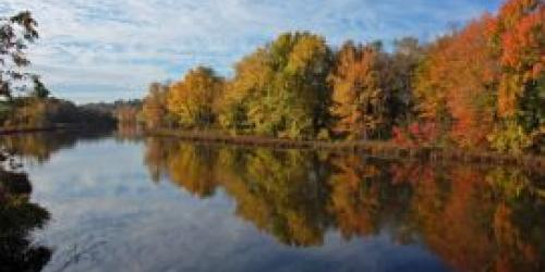 A screen snip of the image on the cover of the Basin 3 Tactical Basin Plan.  It shows a calm river with autumn foliage lining the shore.
