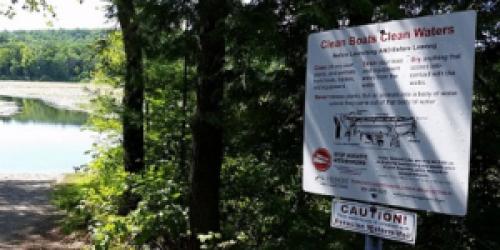 Aquatic Invasive Species sign at a boat launch.