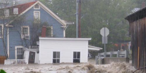 Flooded buildings next to covered bridge