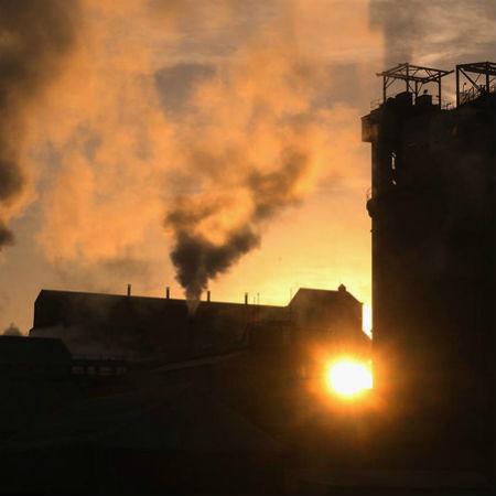 building with stacks emitting pollution