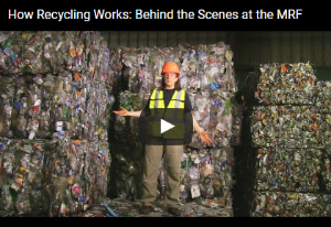 Screen Shot of a Materials Recovery Facility Video Tour Link; the image is a worker standing in front of bales of recyclables