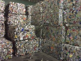 A photo of stacked bales of aluminum cans waiting to be recycled