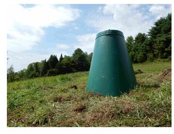 Photo of a "Green Cone" digester installed in a grassy area