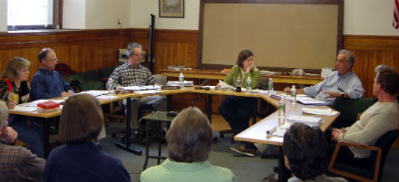 a group of people meeting around a table