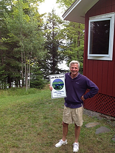 Man holding Lake Wise Award