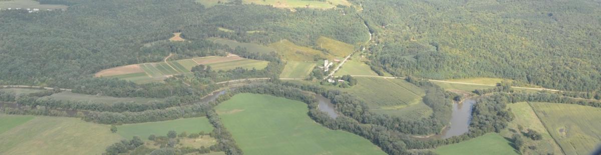 Aerial view of river corridor and surrounding fields and wooded areas